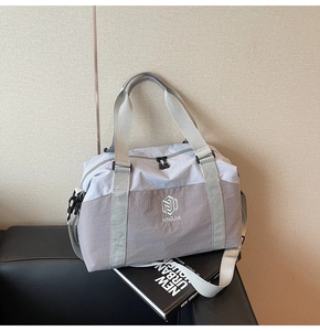Close-up of a gray travel bag featuring dual zippers and durable nylon fabric texture