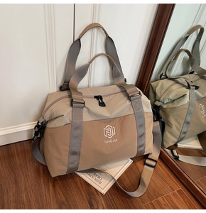 Macro detail of canvas travel bag with NINGJIA embroidery and adjustable nylon strap