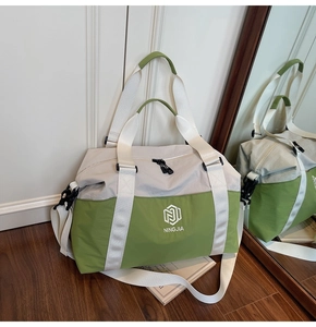Spacious light grey and green travel bag with wide straps in a clean home setting