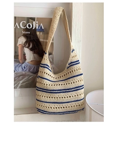 Close-up of beige and blue crochet knit pattern and textured weave on large tote bag