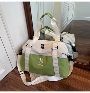 Detail of travel bag with NINGJIA logo, reinforced handles and nylon crossbody strap