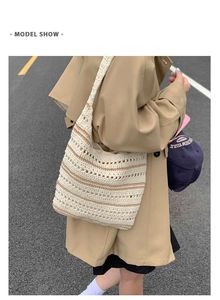 Detailed street style shot of the hollow crochet weave pattern and two-tone stripe design