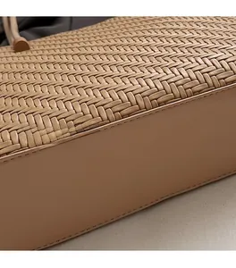 Close-up of intricate woven texture and precise stitching on camel tote bag