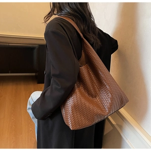 Brown woven leather hobo bag styled with a professional black blazer for work