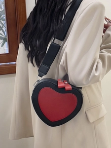Fashionable heart-shaped crossbody bag in red and black color block with wide strap