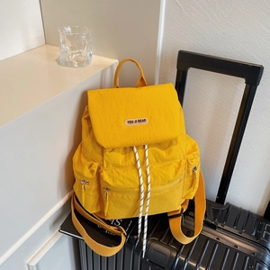 Fashionable bright yellow large capacity nylon backpack on luggage for travel and school