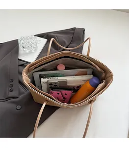 Top view of spacious woven tote bag showing internal storage for tablet and essentials