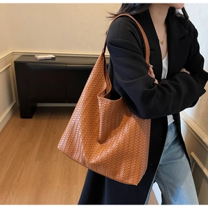 Brown woven leather hobo shoulder bag styled with a minimalist black blazer outfit