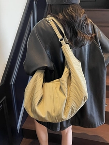 Minimalist large khaki tote bag with quilted texture and wide shoulder strap