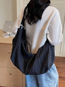 Minimalist black pleated tote bag for women with large capacity and crescent design