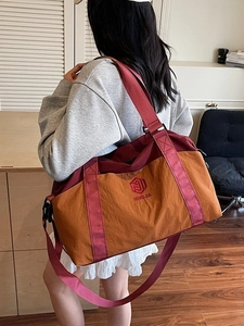 Large orange and maroon travel bag with dry-wet separation and adjustable shoulder straps