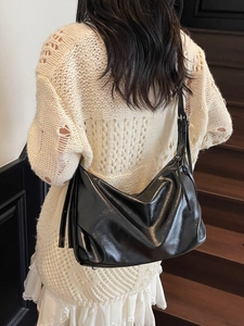 Minimalist black patent leather tote bag with adjustable strap for daily commute