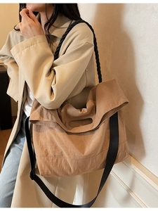 Khaki large capacity tote bag with chunky rope handle and crossbody strap on a model