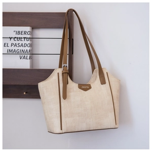 Detail of beige woven tote bag with brown leather handles and stitched JINGPIN label