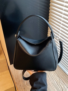 Elegant black lychee grain leather handbag with top handle and adjustable shoulder strap