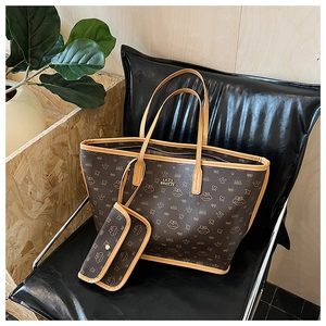 Detail of the brown monogram tote bag with a small pouch on a leather seat