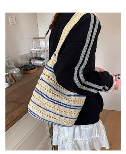 Detail of the oversized crochet tote bag featuring blue stripes and a breathable mesh design