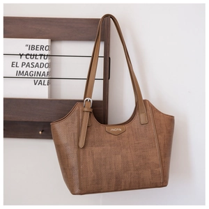 Detail of dark brown tote bag with woven texture and Jingpin logo on wooden stand