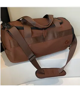 Vue détaillée du grand sac de sport marron foncé avec sangle réglable et boucles en métal