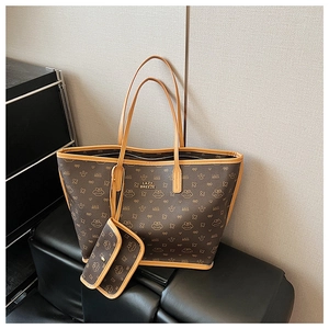 Brown tote bag set with cartoon bear patterns and matching small pouch on black surface