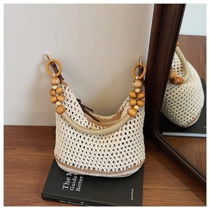 Détail du sac tricoté évidé avec perles en bois naturel et texture crochetée