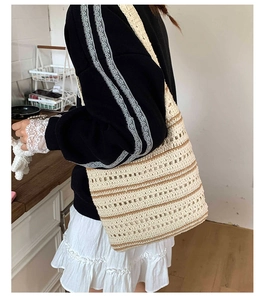 Detail of hand-woven striped tote bag with textured open-knit pattern and broad strap
