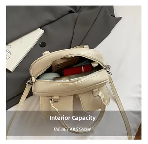 Detail showing internal capacity of the beige leather bag with phone and cosmetics