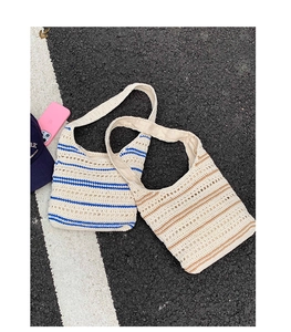 Detail of hand-woven crochet hobo bags with blue and brown stripes and fabric lining