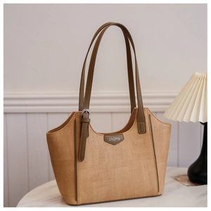 Detailed woven texture of khaki tote bag with premium leather straps and logo patch