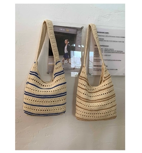 Close-up of handmade crochet tote bags featuring navy and brown horizontal stripes