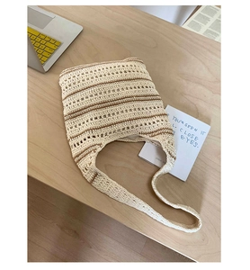 Detail of hand-woven striped tote bag with contrast beige and brown textured stitching