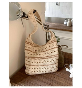 Detail of handmade crochet shoulder bag with brown stripes and soft fabric inner lining