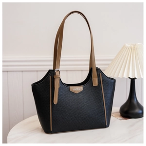 Detail of black woven leather tote bag with brown contrast straps and JINGPIN branding
