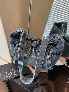 Vintage blue washed denim crossbody bag with multiple zipper pockets and adjustable strap