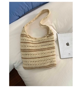 Detail of hand-woven hollow knit tote bag featuring beige and brown horizontal stripes
