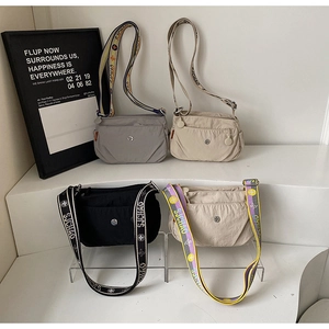 Collection of nylon crossbody bags in grey, brown, black and cream with jacquard straps