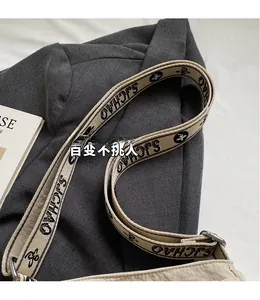 Detail of adjustable canvas shoulder strap with SJCHAO lettering on casual crossbody bag