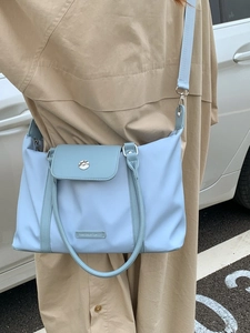 Waterproof light blue nylon travel bag with crossbody strap for sports and gym use