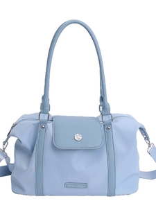 Light blue waterproof travel tote with top handles and adjustable shoulder strap for gym