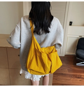 Detailed back view of a yellow casual nylon crossbody tote showing texture and size