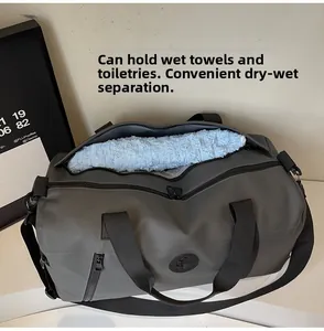 Detail view of the dry-wet separation compartment in the gray nylon travel bag