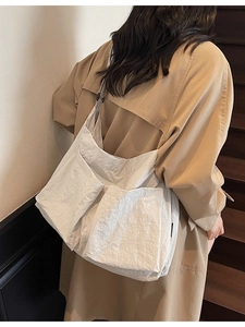 Minimalist white multi-pocket canvas tote bag with a spacious design for daily casual wear
