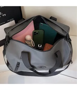 Macro view of the spacious interior of grey travel bag with various personal items inside