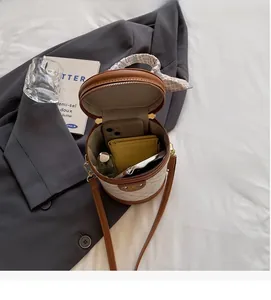 Internal view of quilted bucket bag showing phone, wallet and perfume storage capacity