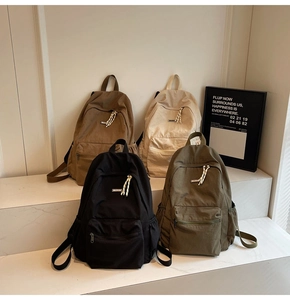 Multiple colors of minimalist nylon school backpacks displayed in various stylish tones