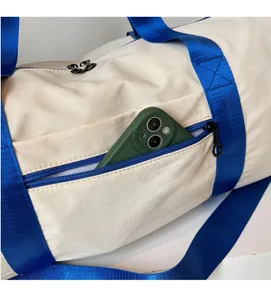 Detail of the side zipper pocket on a travel bag with a smartphone inside for size