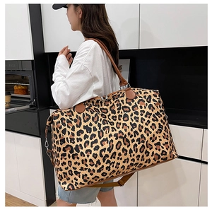Large capacity leopard print travel bag with brown leather handles and adjustable shoulder strap