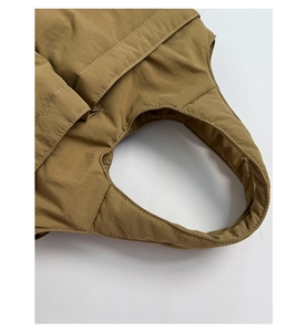 Detail of khaki quilted tote bag showing white stitching and padded handle texture