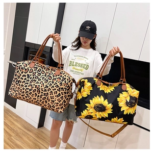 Detailed view of leopard print and sunflower travel bags with leather handles and straps