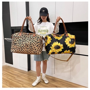 Detail of leopard and sunflower travel bags with premium brown leather straps and handles